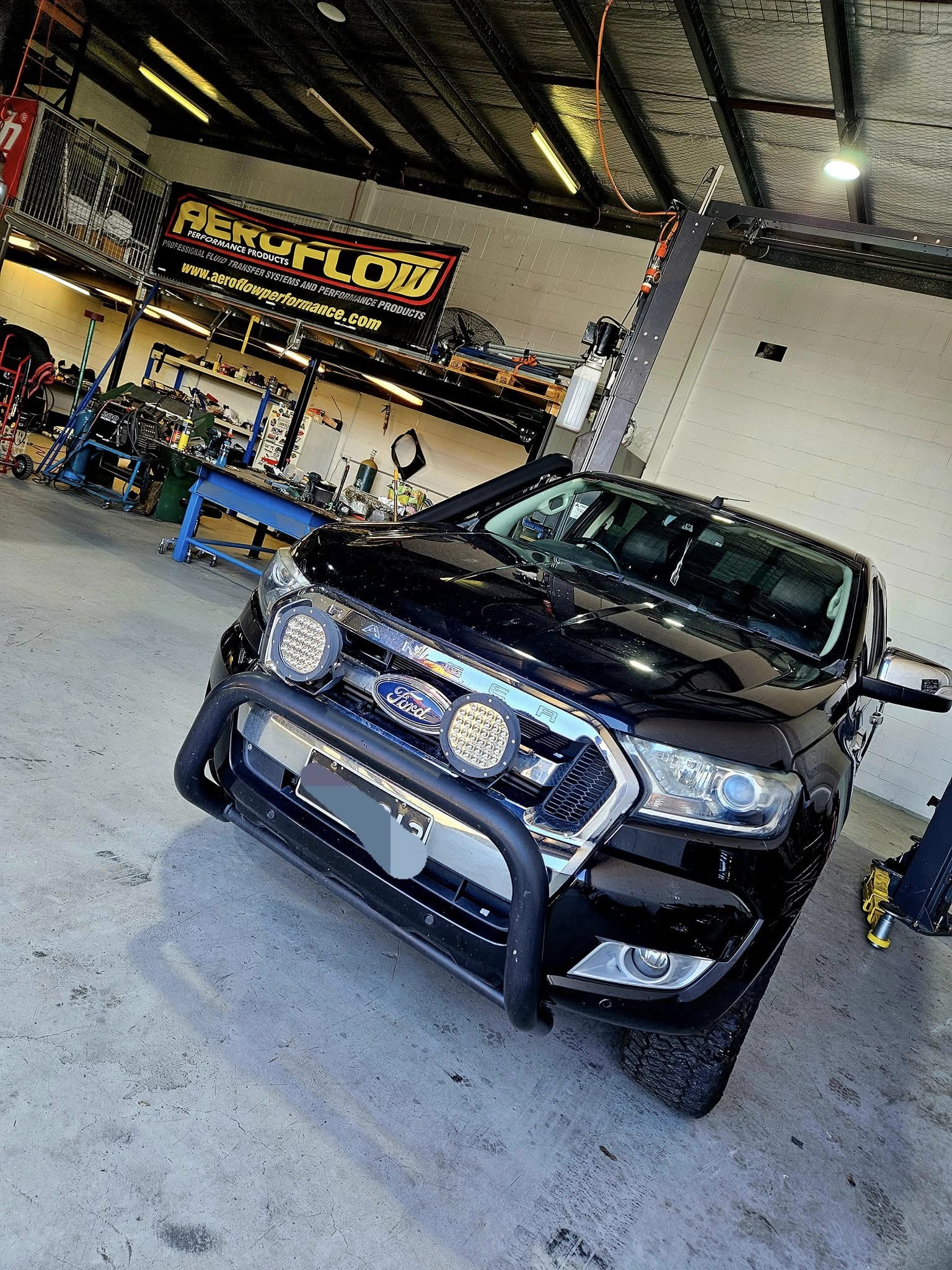 Modified diesel ute being worked on inside the Modified Automotive workshop, Derwent Park